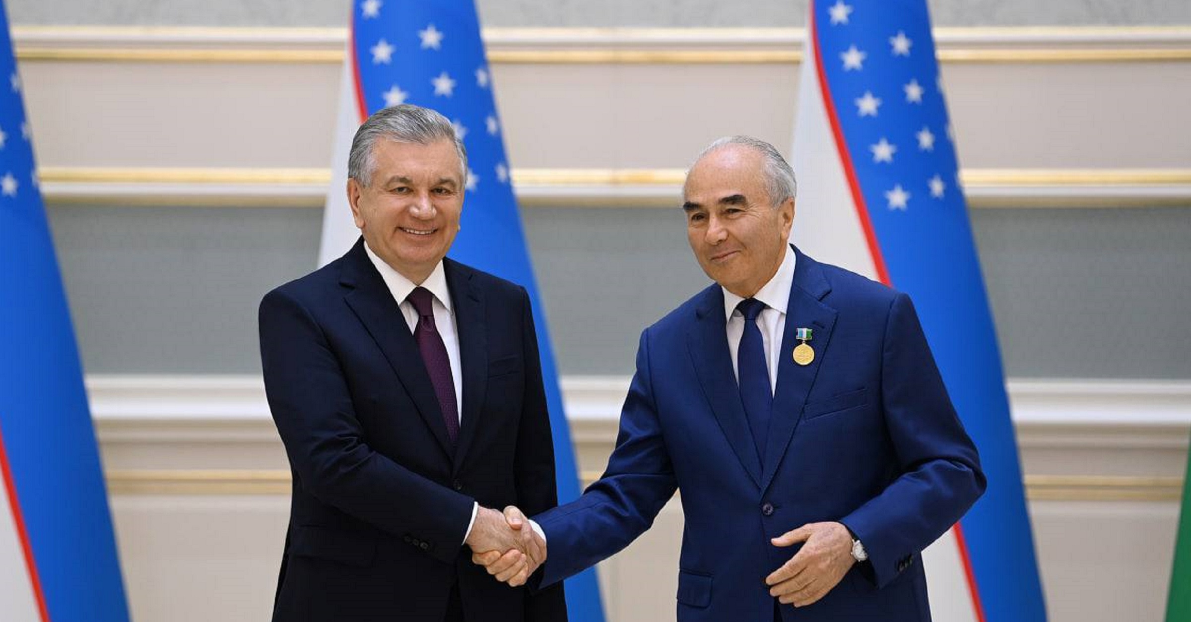The President of the Republic of Uzbekistan Shavkat Mirziyoyev is presenting the title "O‘zbekiston Respublikasi fan arbobi"  to the Rector of Samarkand State University, Professor Rustam Kholmurodov